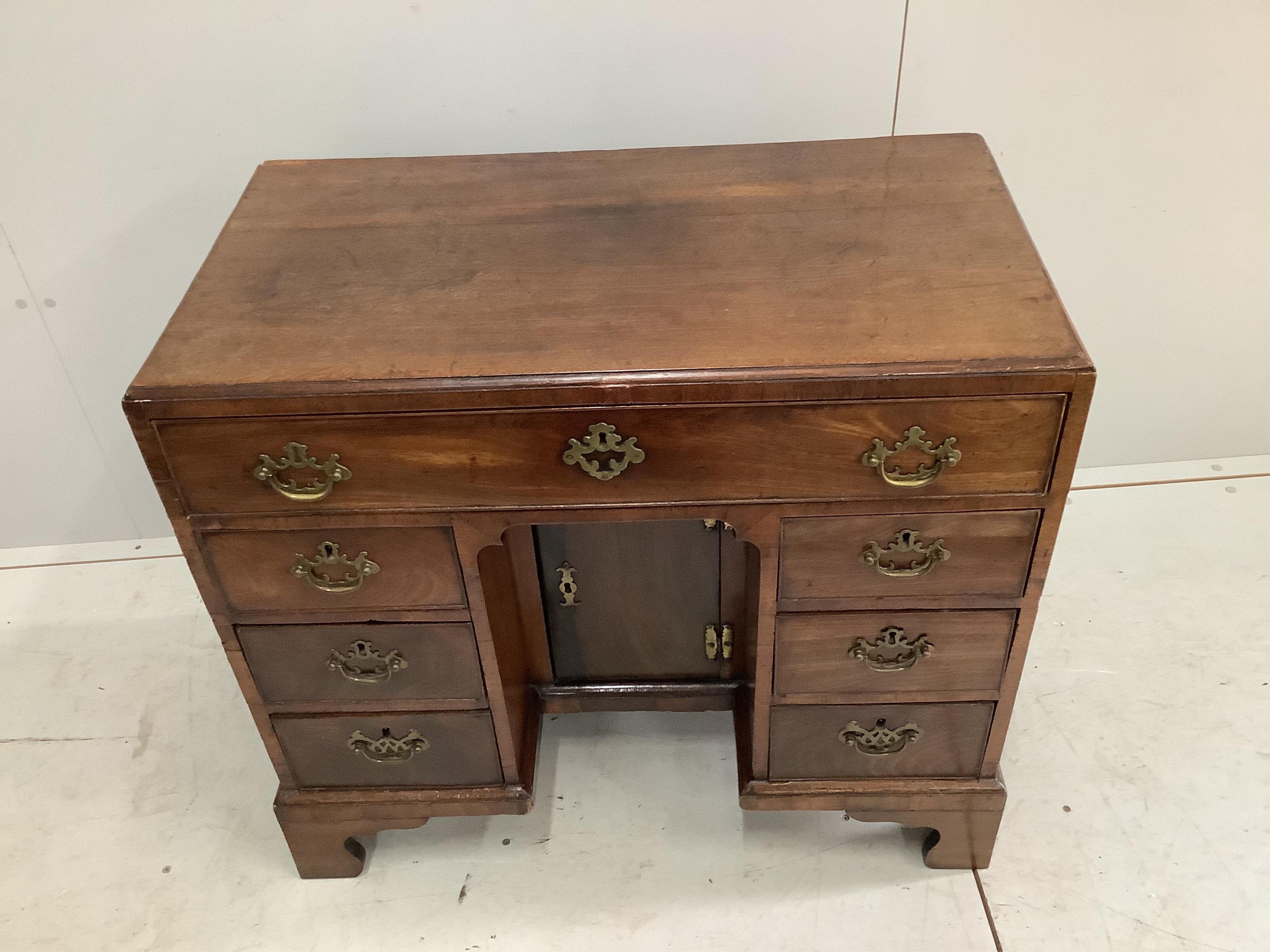 A George III mahogany kneehole desk, width 83cm, depth 44cm, height 76cm. Condition - fair